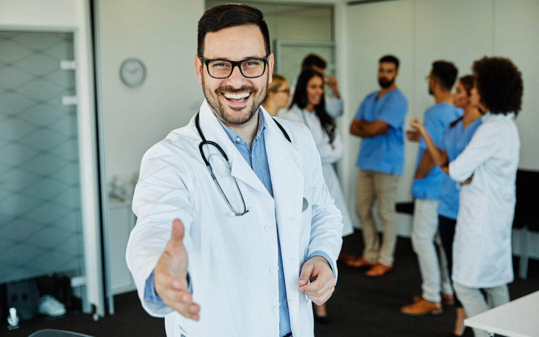 A doctor greeting an employee with a warm smile and handshake, the epitome of what employee appreciation events make you feel like.