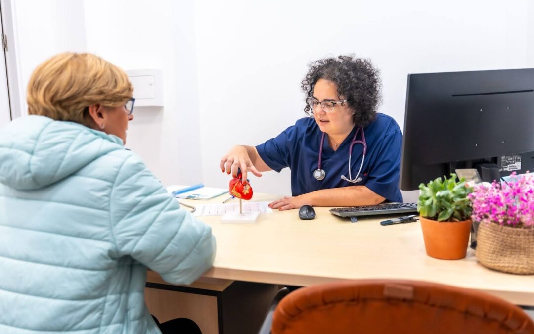 A provider demonstrating the importance of compassionate care in the TrueCare mission as she works patiently and happily with an elderly client.