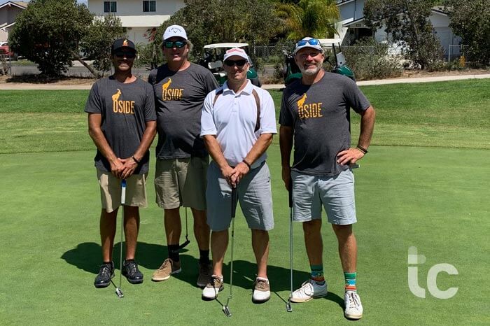 4 men golfers standing on the green posing for the camera