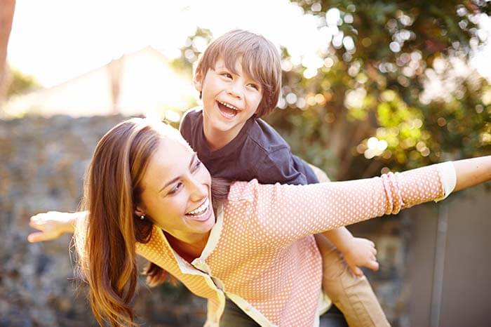 mother playing outside with son